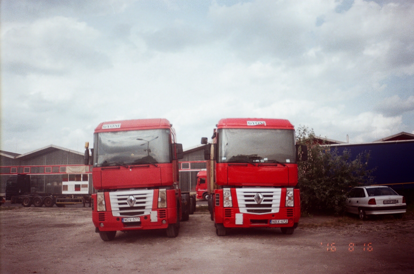 A photo of two red Renault semi trucks
