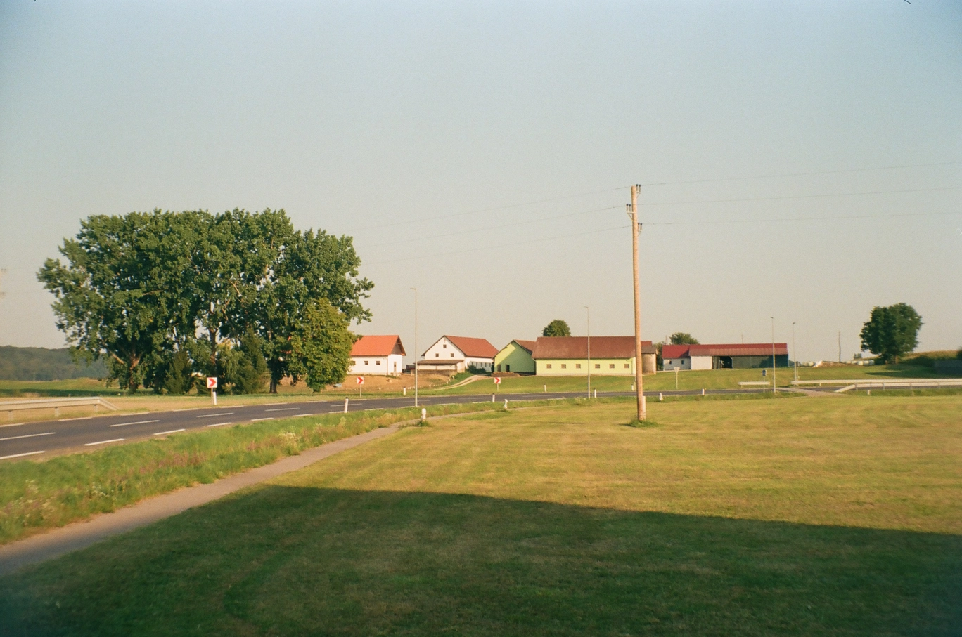 A photo of some rural houses during sunset