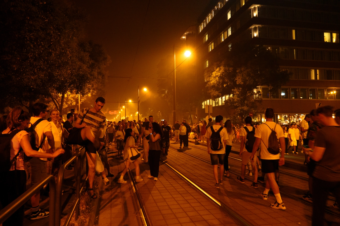 A photo of a crowd of people on the street
