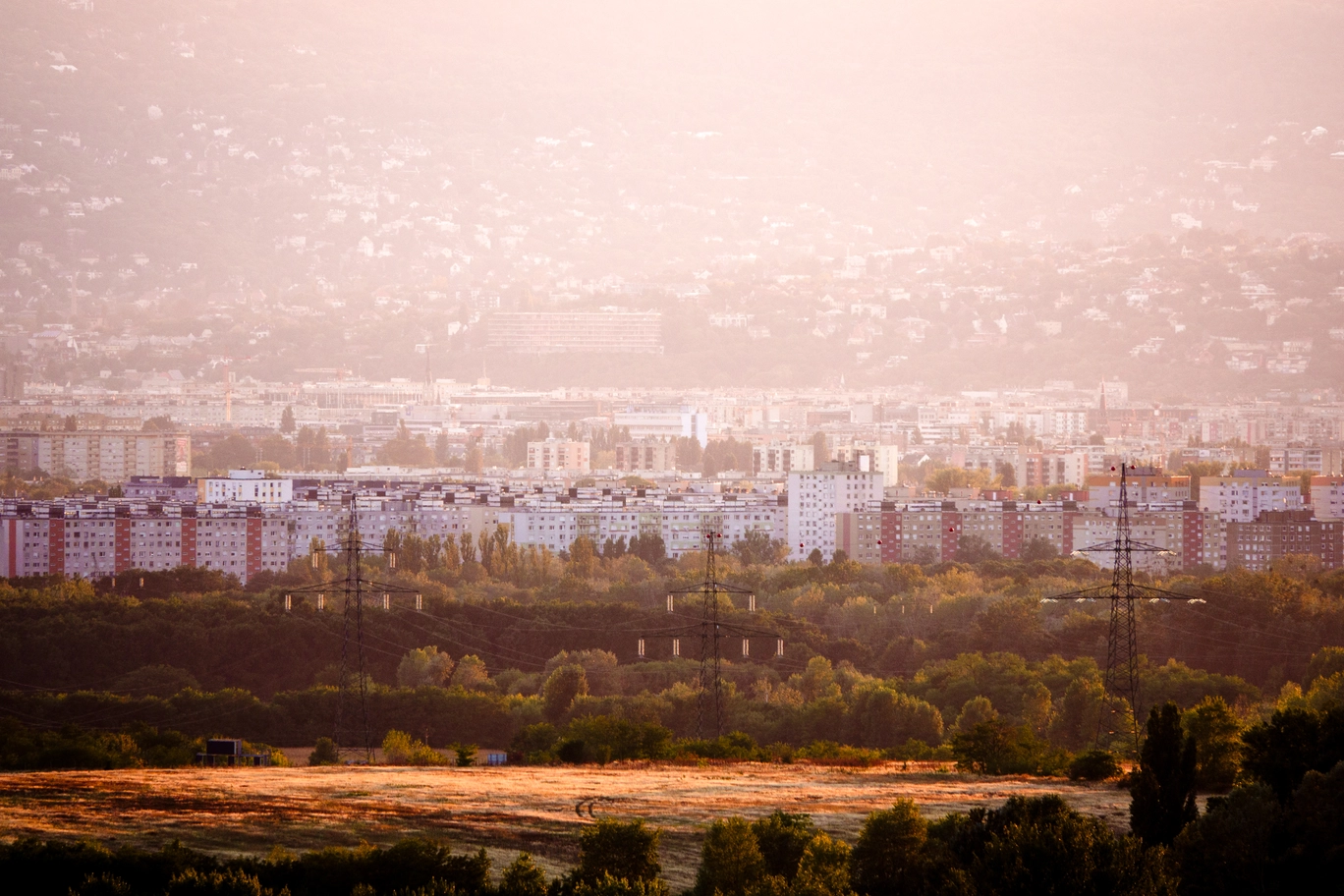 A photo of power lines with a cityscape in the background
