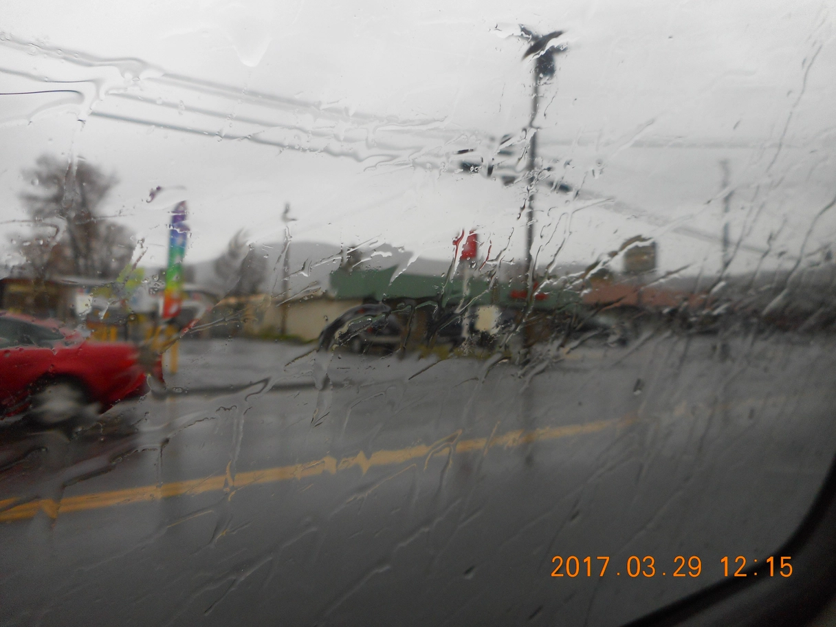 A photo of rain on a car window