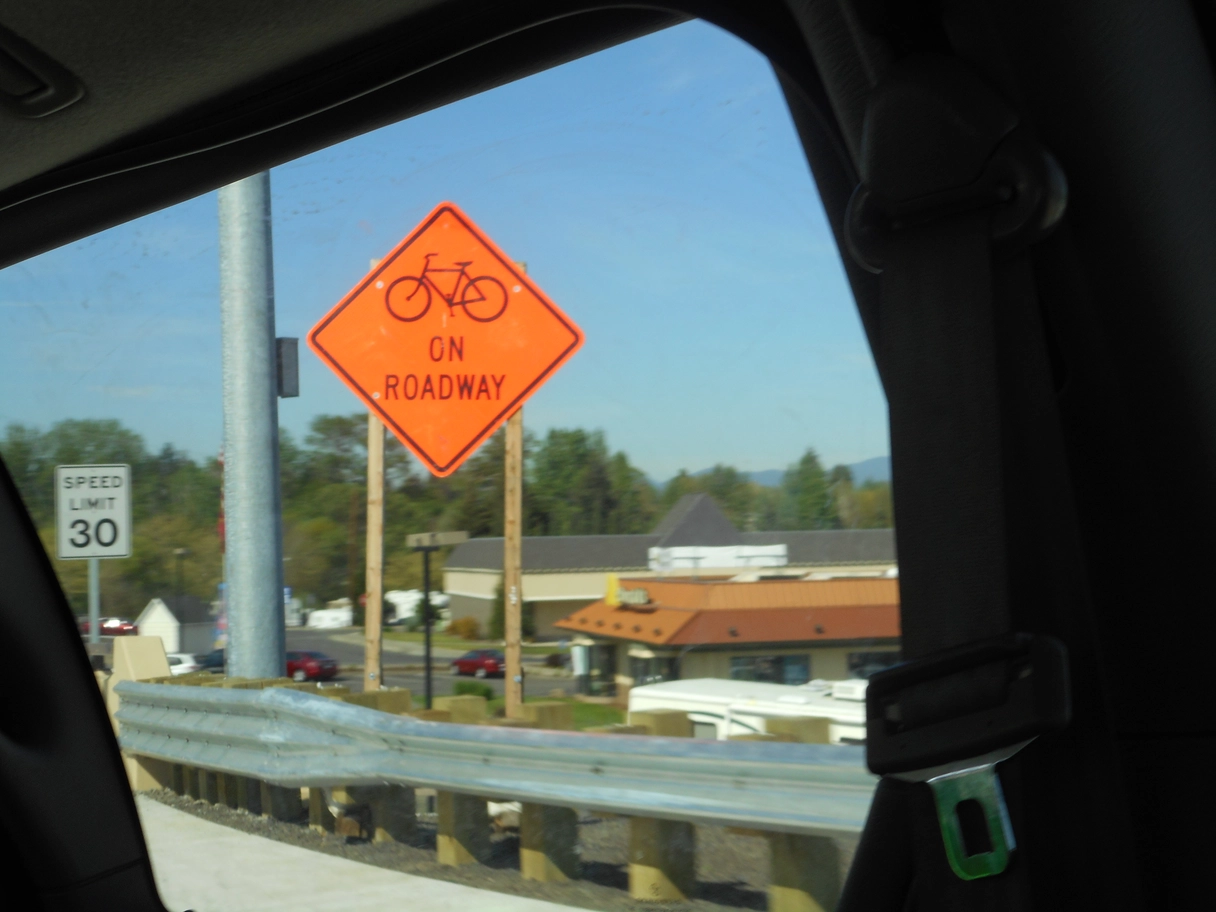 A photo of a bicycles on roadway sign
