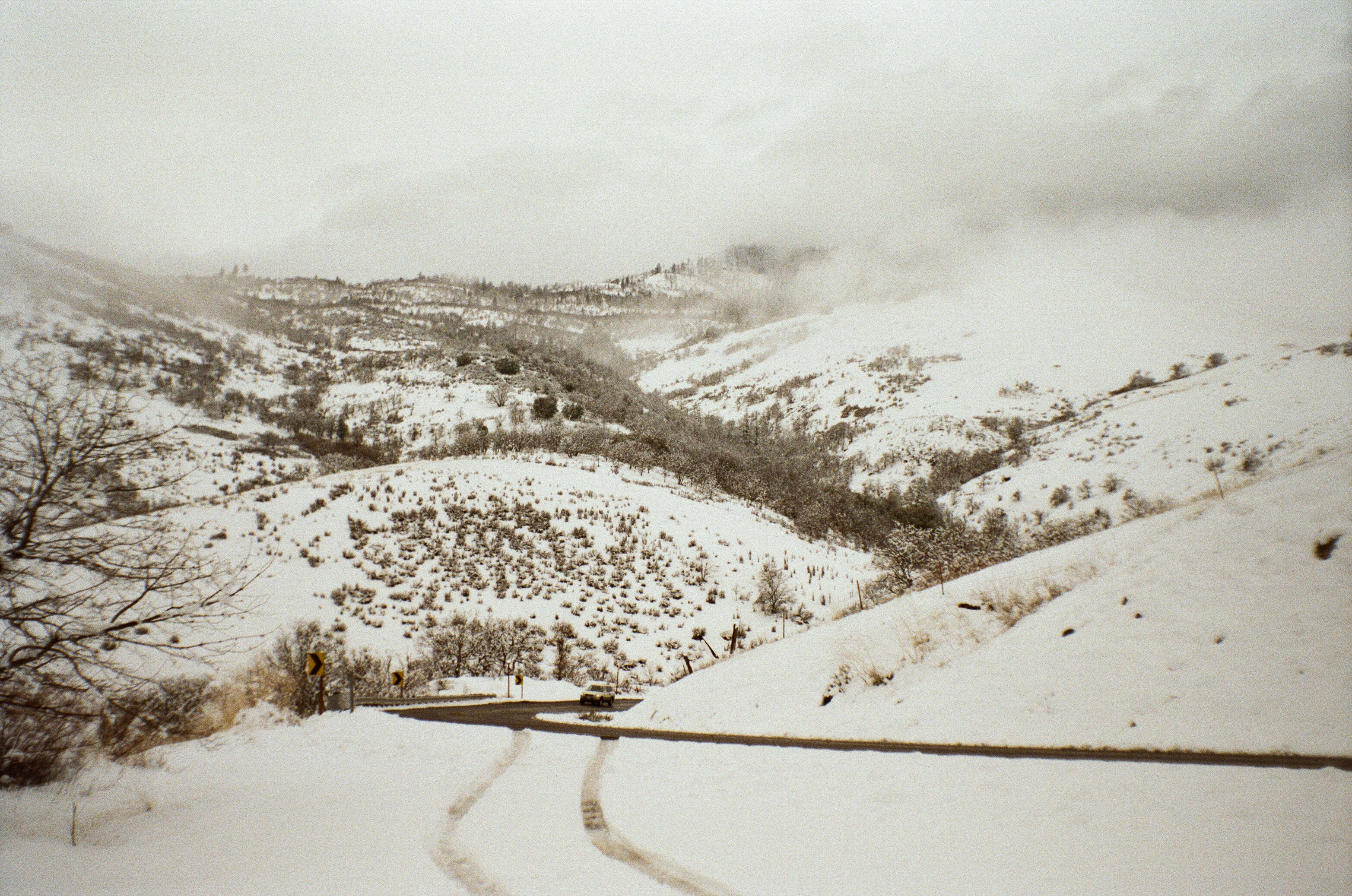 A photo of a snowy mountain road