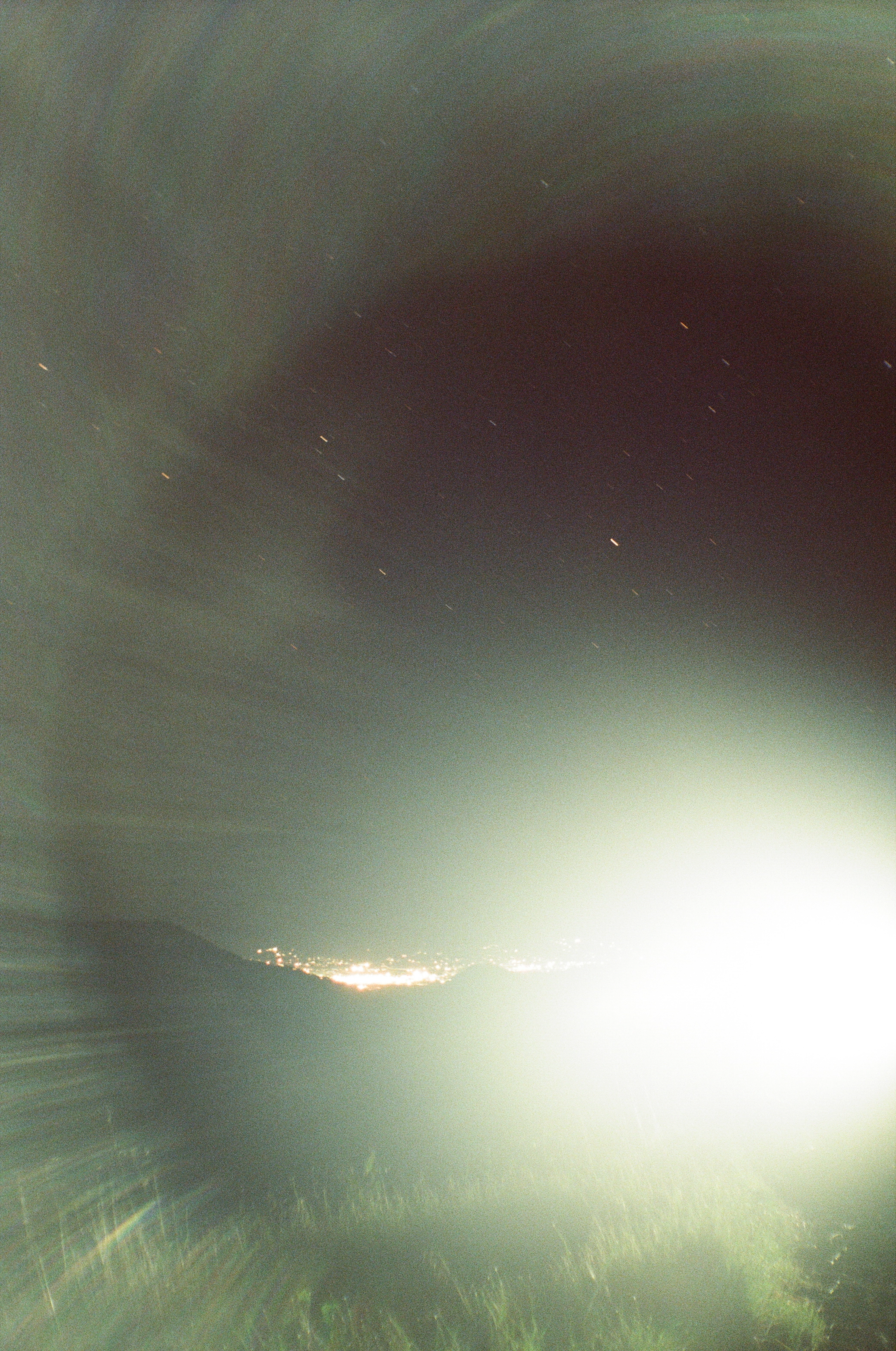 A photo of car headlight ruining a landscape star streak shot