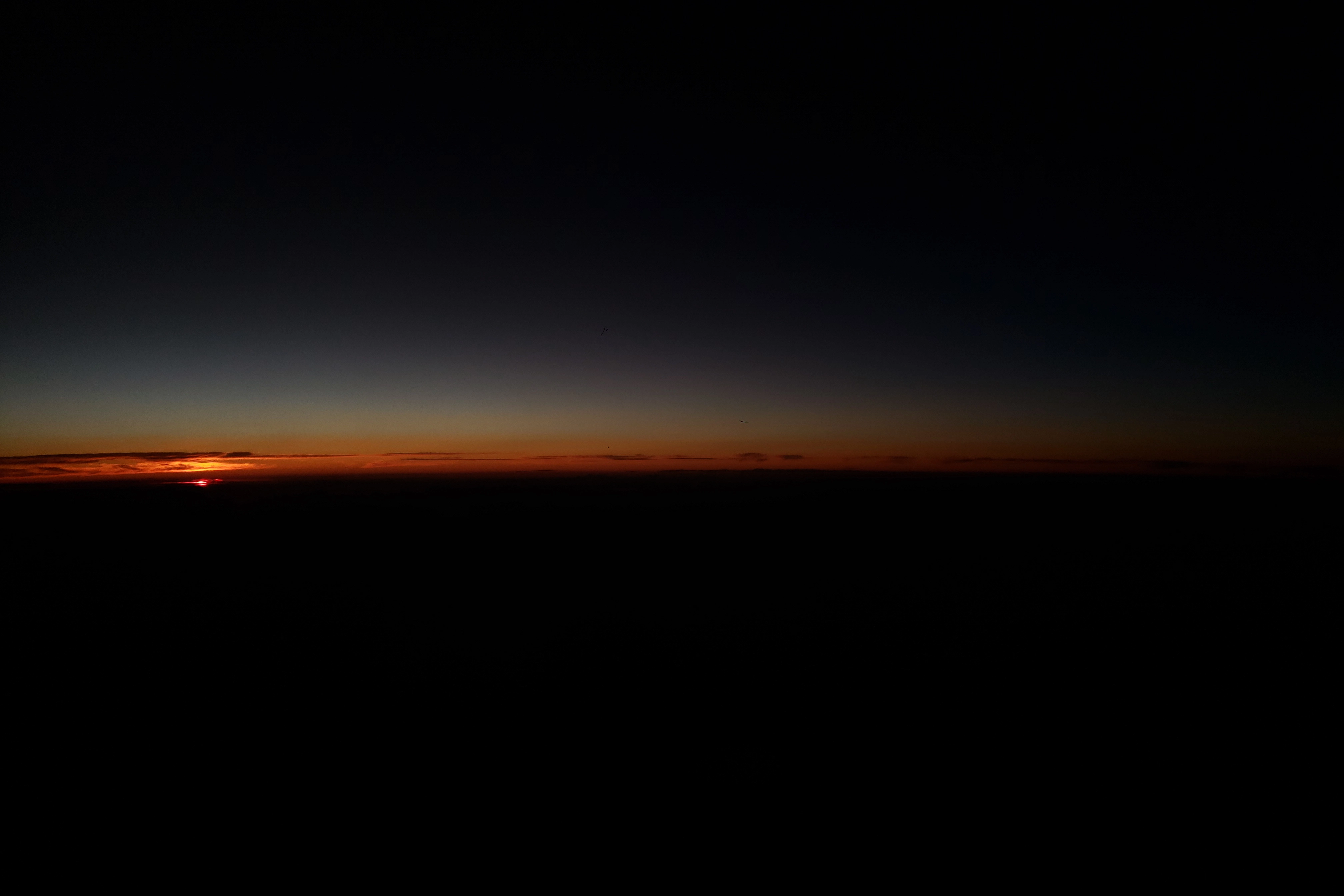 A photo of the sunset from an airplane