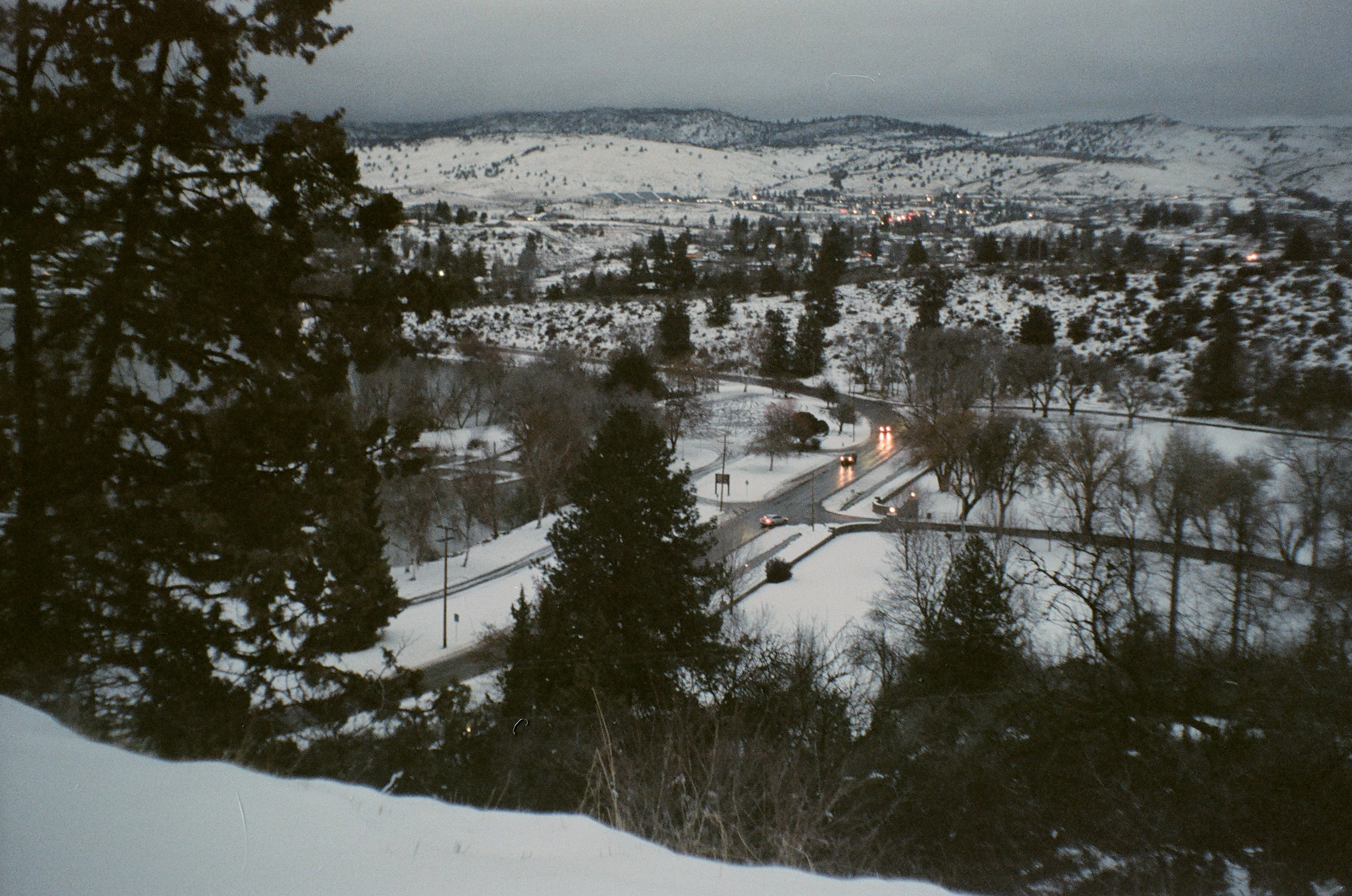 An arial shot of a snow covered Moore park at dusk