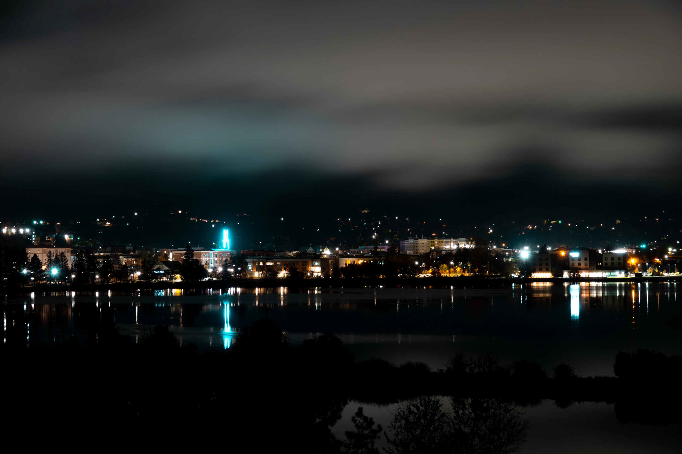 A photo of downtown Klamath Falls reflecting off the lake at night