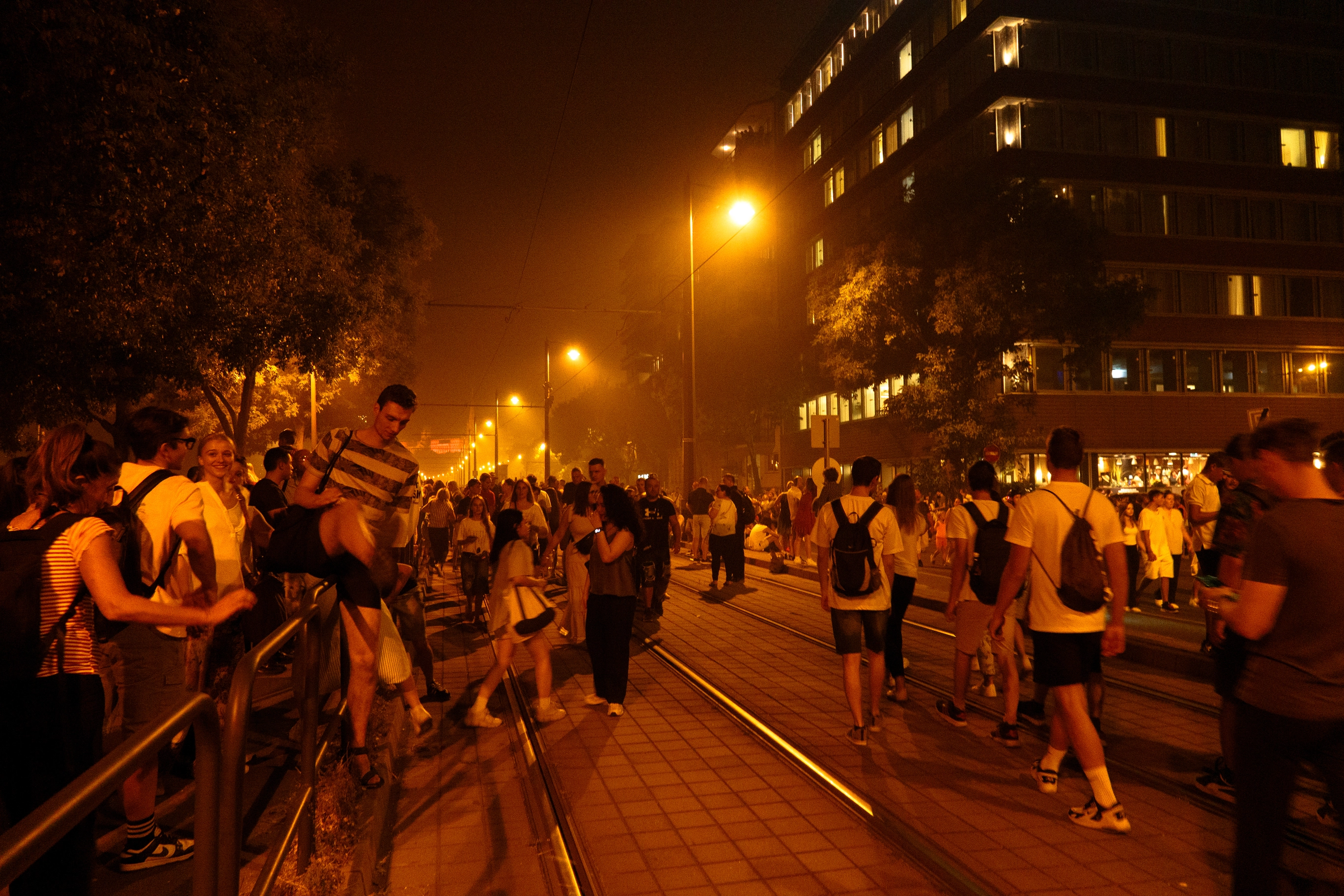 A photo of a crowd of people on the street