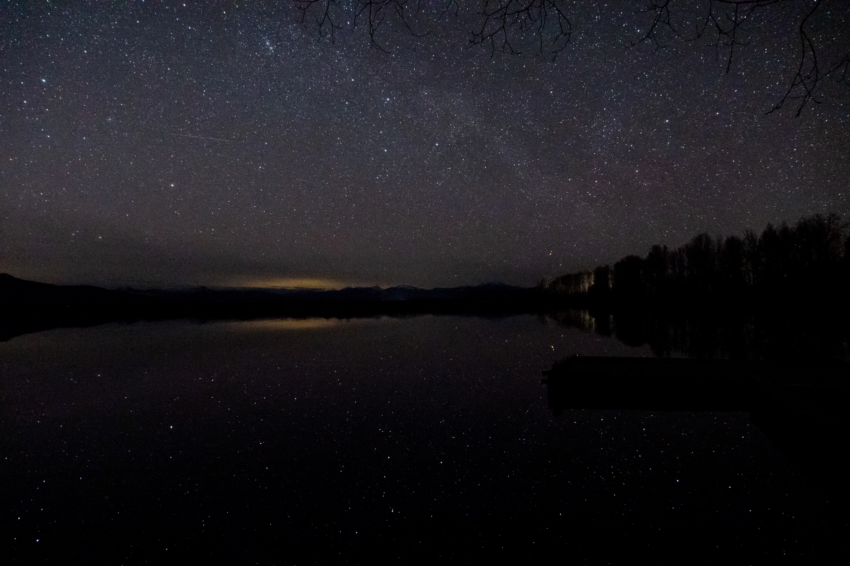 A photo of the night sky over a lake