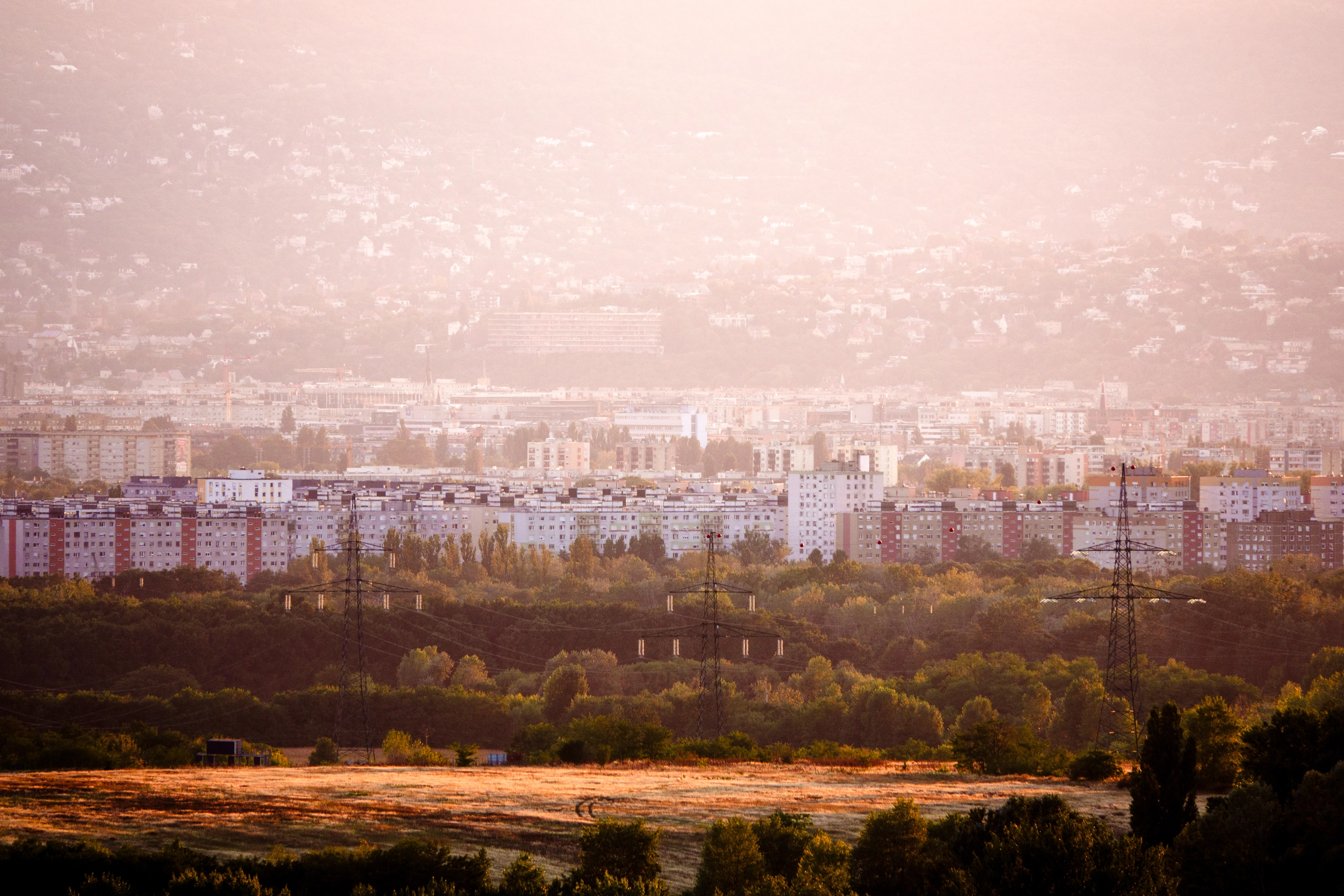 A photo of power lines with a cityscape in the background