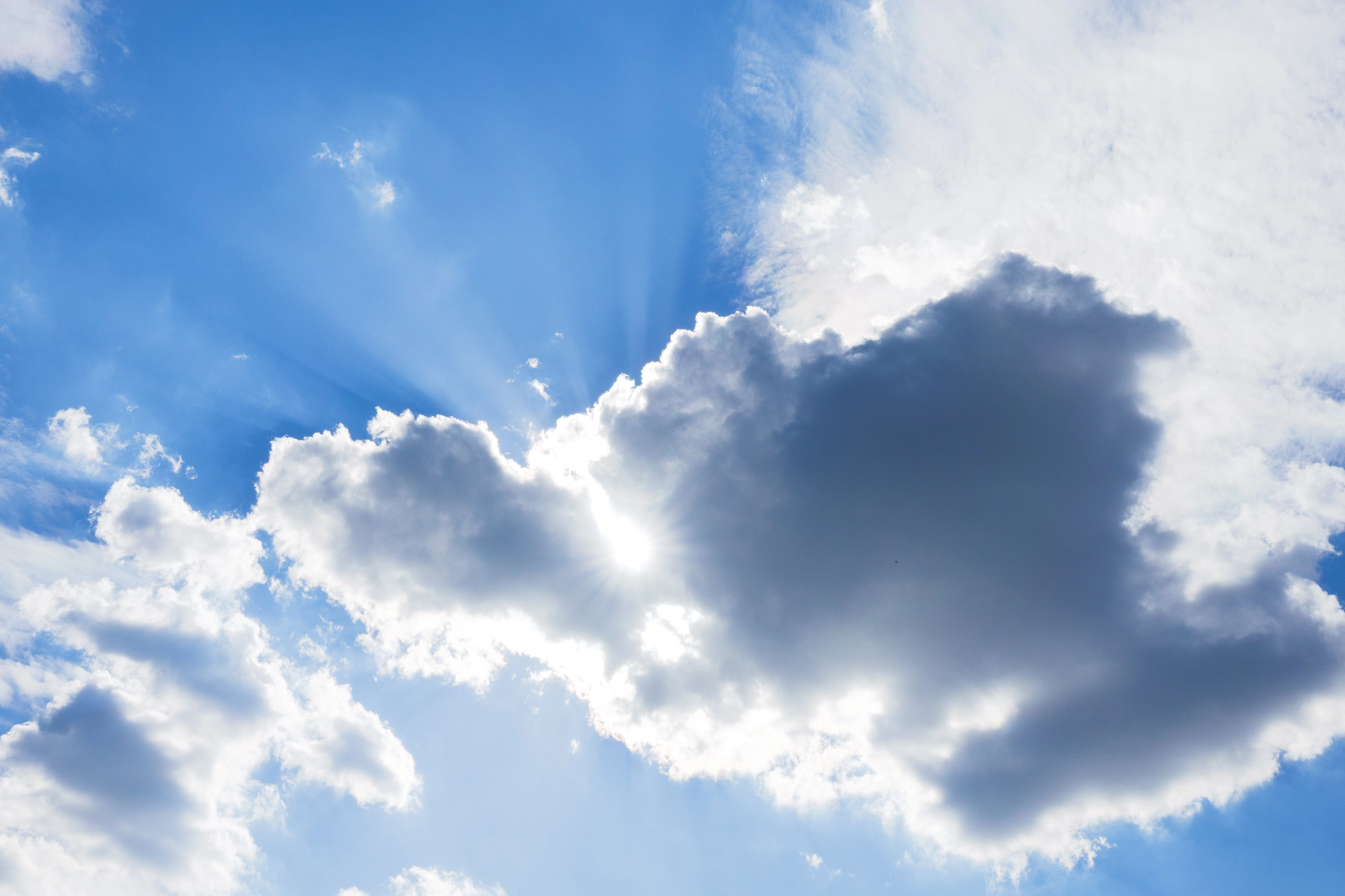 A photo of the sun beaming through the clouds