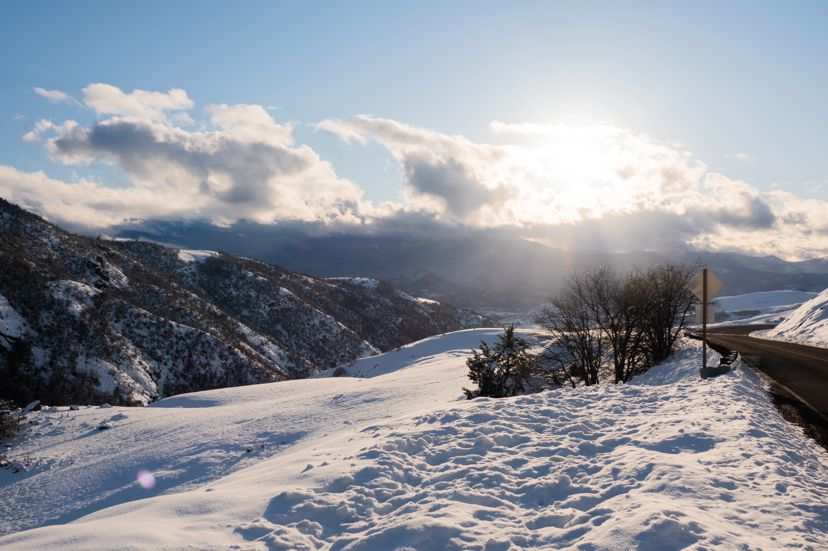 A photo of snowy mountains and the sun